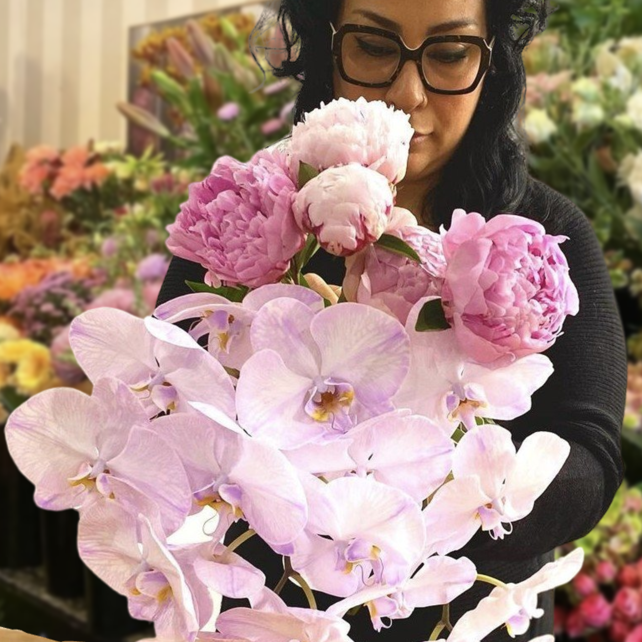 Perrotts Florist arranging flowers against a table of flowers