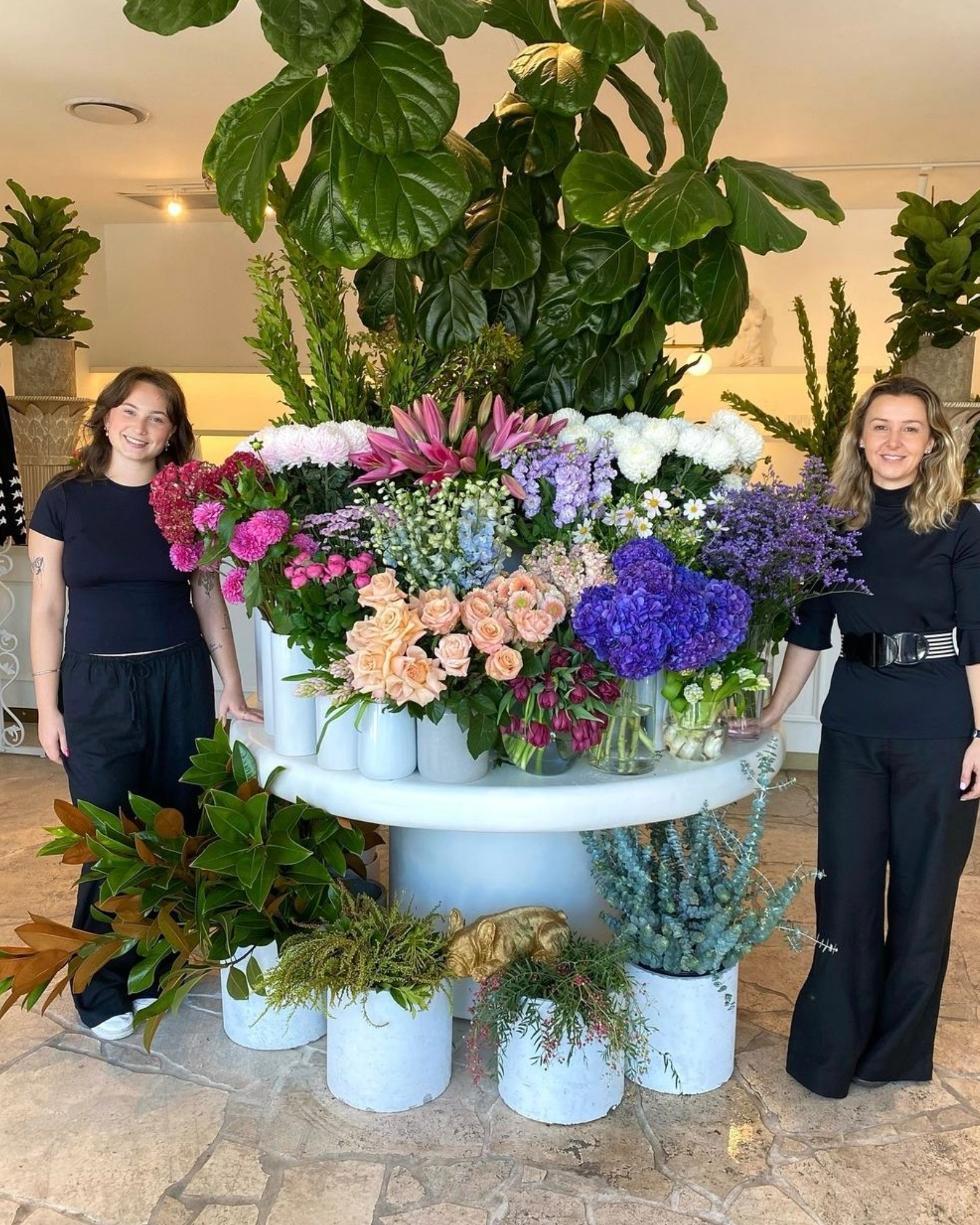 Florists besides table of seasonal flowers Hawthorne store